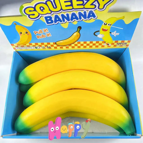 Three bright yellow and green toy bananas in a blue box labeled "Squeezy Banana."