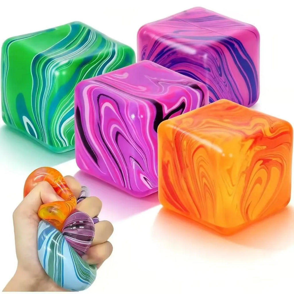 Colorful marbled stress cubes in green, pink, purple, and orange; hand squeezing a multicolor ball.