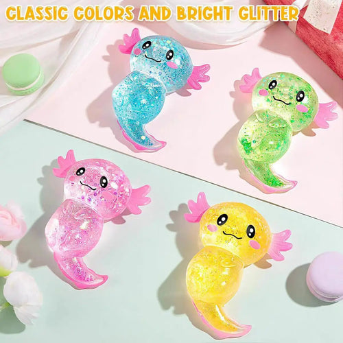 Four pastel glittery axolotl toys in blue, green, pink, and yellow on a light surface.